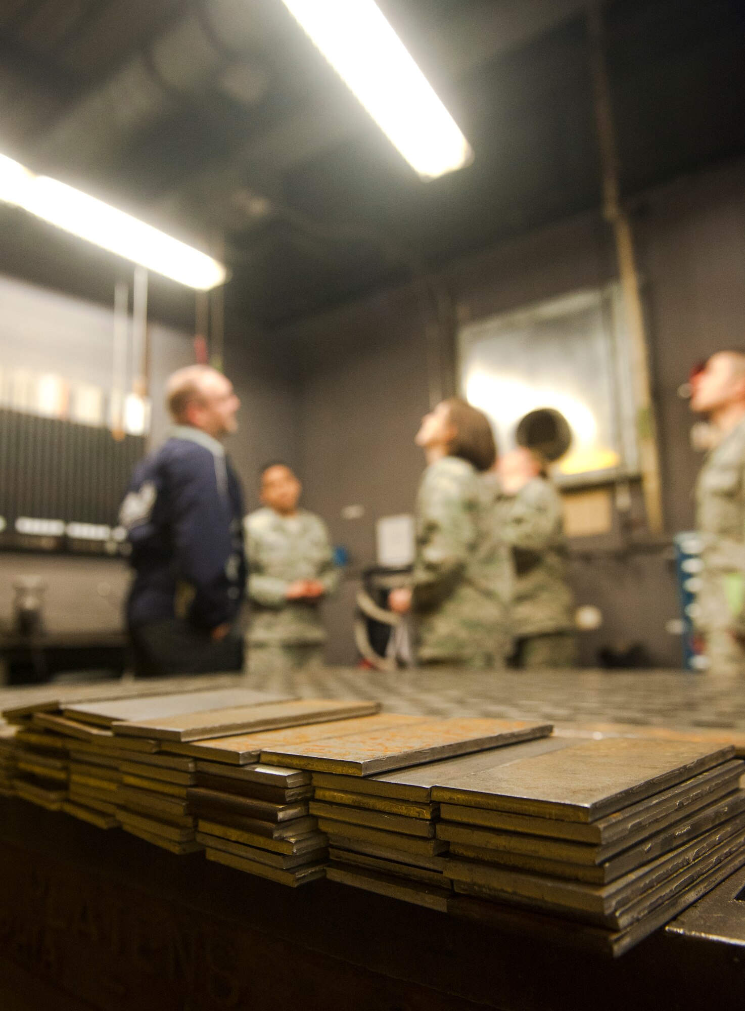 A stack of metal sits on a workbench as bioenvironmental Airmen conduct a health-risk assessment of the 23d Equipment Maintenance Squadron metals technology shop at Moody Air Force Base, Ga., March 25, 2013. Bioenvironmental Airmen ensure Airmen are wearing proper personal protective equipment and that they are not being unnecessarily exposed to hazardous chemicals while on the job. (U.S. Air Force photo by Senior Airman Jarrod Grammel/Released) 
