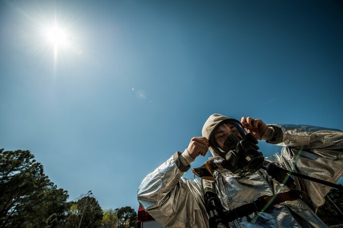 Airman 1st Class Michael Shonebarger, 628th Civil Engineer Squadron firefighter, dons his gas mask during an aircraft, live-fire training exercise March 29, 2013, at Joint Base Charleston – Air Base, S.C. The base performs quarterly aircraft, live-fire training for firefighters and crew chiefs to maintain their qualifications. (U.S. Air Force photo/ Senior Airman Dennis Sloan)