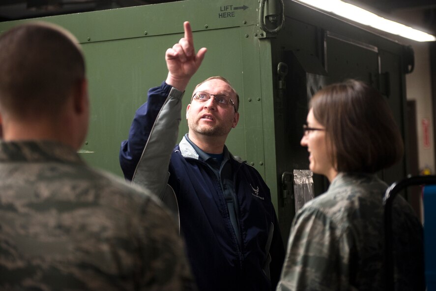 Ryan Fictum, a senior occupational health and safety specialist, points to a ventilation system as bioenvironmental Airmen look on during a health-risk assessment at Moody Air Force Base, Ga., March 25, 2013. During health-risk assessments, bioenvironmental Airmen look for possible hazards to help ensure short-term and long-term safety of Airmen. (U.S. Air Force photo by Senior Airman Jarrod Grammel/Released)

