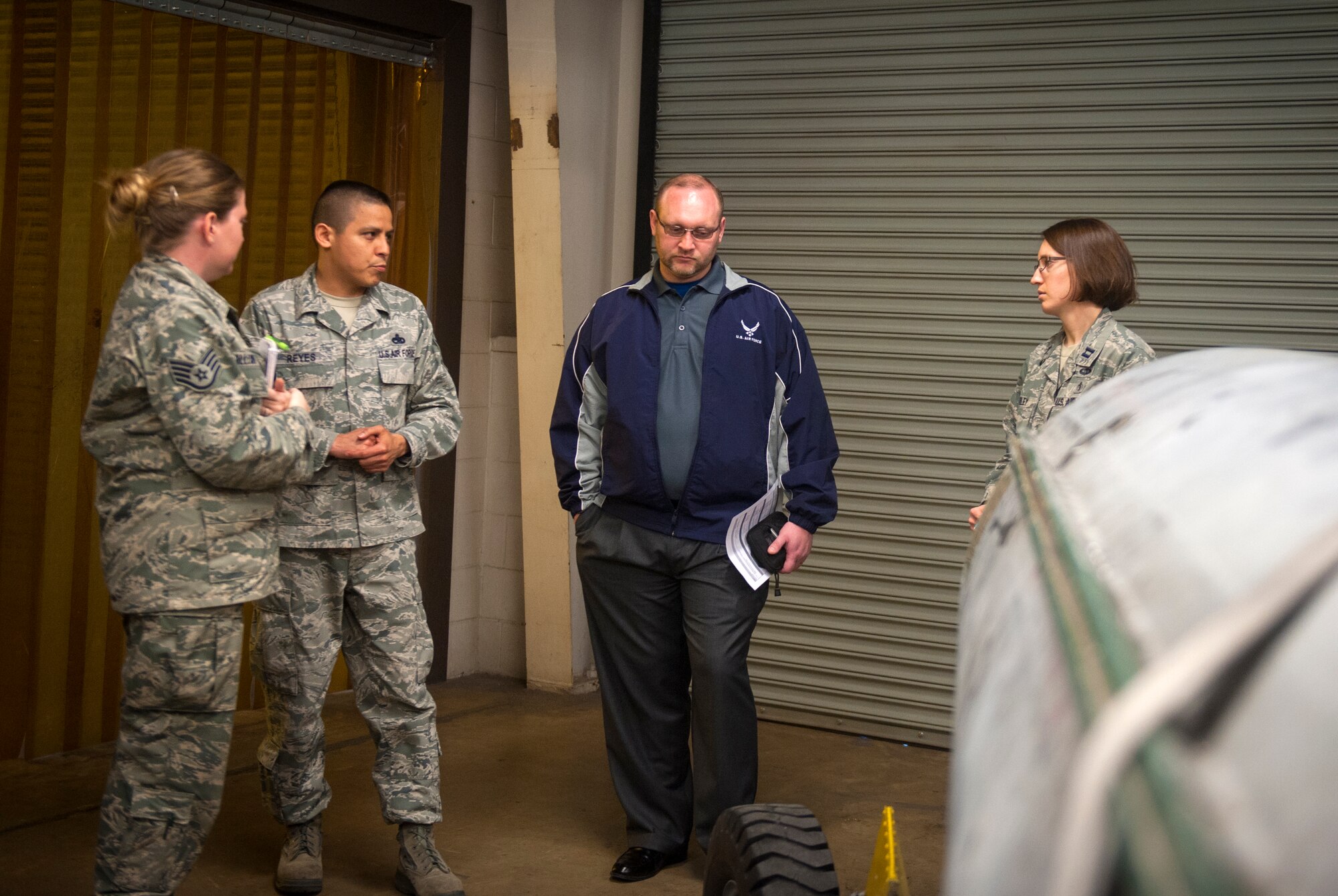 U.S. Air Force Master Sgt. Felipe Reyes, 23d Equipment Maintenance Squadron NCO in charge of aircraft metals technology, talks to Staff Sgt. Krisiti Gillespie (far left), 23d Aerospace Medicine Squadron industrial hygiene team leader, Ryan Fictum (second from right), a senior occupational health and safety specialist, and Capt. Stephanie Harley, 23d AMDS Bioenvironmental Engineering Flight commander, about possible work-place hazards at Moody Air Force Base, Ga., March 25, 2013. Bioenvironmental Airmen conduct health-risk assessments to ensure units are within Occupational Safety and Health Administration regulations. (U.S. Air Force photo by Senior Airman Jarrod Grammel/Released) 
