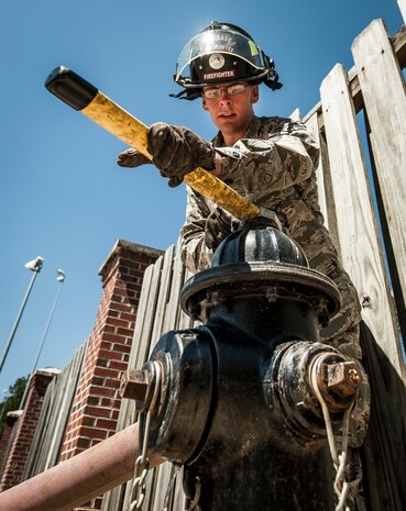 Airman 1st Class Andrew Spratt, 628th Civil Engineer Squadron firefighter, opens a fire hydrant during an aircraft, live-fire training exercise March 29, 2013, at Joint Base Charleston – Air Base, S.C. The base performs quarterly aircraft live-fire training for firefighters and crew chiefs to maintain their qualifications. (U.S. Air Force photo/ Senior Airman Dennis Sloan)