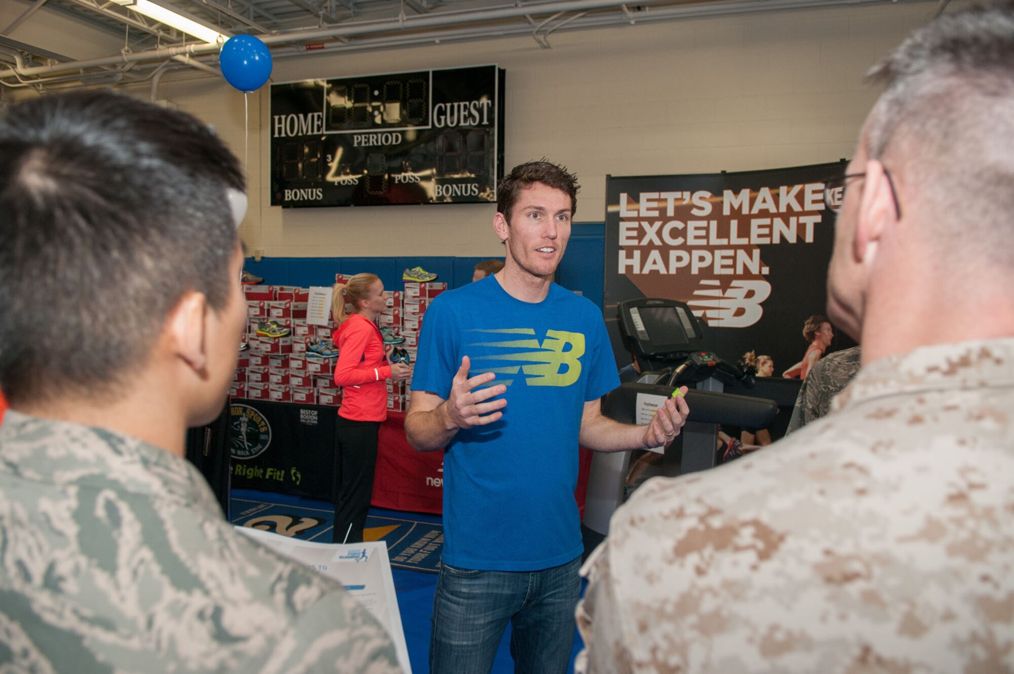 HANSCOM AIR FORCE BASE, Mass. – Sean Burris, from New Balance, talks to military personnel about good running techniques and the proper shoes to wear at the Health and Fitness Expo March 27 at the Fitness and Sports Center.  A variety of base agencies, local businesses and organizations attended the event to provide health screenings, tips, samples, demonstrations, giveaways, information and more. (U.S. Air Force photo by Rick Berry)