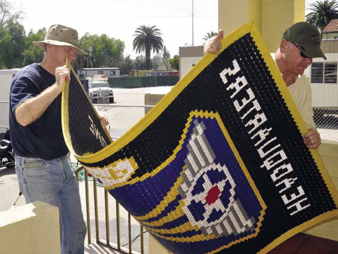 Lt. Col. Rick Wilson, left, and Col. Jeffrey Robertson replace the welcome mat after a thorough washing, during the 4th Air Force spring cleaning day, March 15. (U.S. Air Force photo by Darnell Gardner)