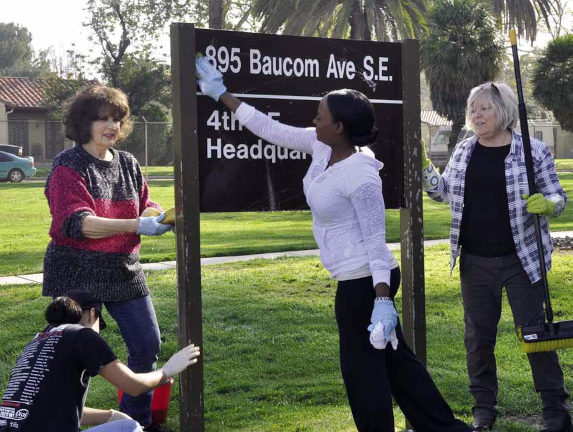 Shown from left to right, Tech. Sgt. Susy Granillo, Beverly Bone, Senior Master Sgt. Tasha Freeman and Master Sgt. Teresa Bertani team up to put a “shine” on the 4th Air Force placard, during their spring cleaning event, March 15. (U.S. Air Force photo by Darnell Gardner)