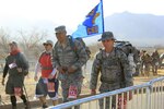 First Lt. Michael Fitisemanu (left) and Master Sgt. Lynn Mortimer, Air Education and Training Command Computer Systems Squadron, take part in the 24th annual Bataan Memorial Death March at White Sands Missile Range, N.M., March 17. (Courtesy photo)