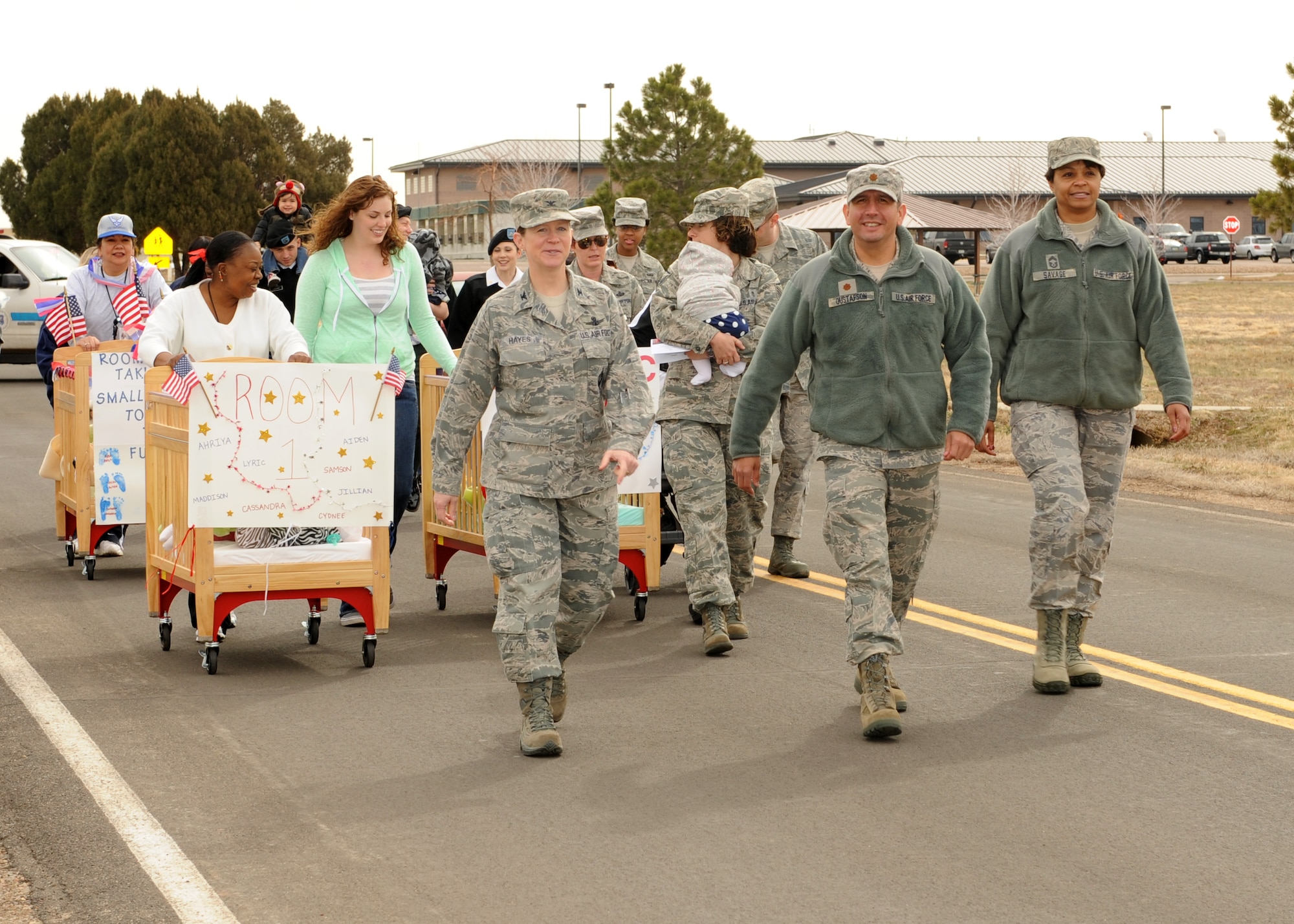Col. Tracey Hayes, 460th Space Wing vice commander; Maj. John Gustafson, 460th Mission Support Group, acting deputy commander; and Chief Master Sgt. Marilyn Savage, 460th MSG, chief of enlisted matters, lead a parade of military children and families down the street March 29, 2013, at Buckley Air Force Base, Colo. April is Month of the Military Child. Children and families make tremendous sacrifices in support of the U.S. military. (U.S. Air Force photo by Senior Airman Marcy Glass/Released)