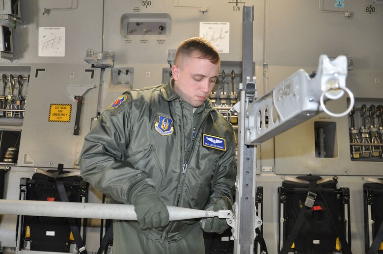 WRIGHT-PATTERSON AIR FORCE BASE, Ohio - Senior Airman Austen Bright, 445th Aeromedical Evacuation Squadron technician, sets up stanchions onboard a 445th Airlift Wing C-17 Globemaster III during a routine training mission March 14. (U.S. Air Force photo/Senior Airman Shen-Chia McHone)