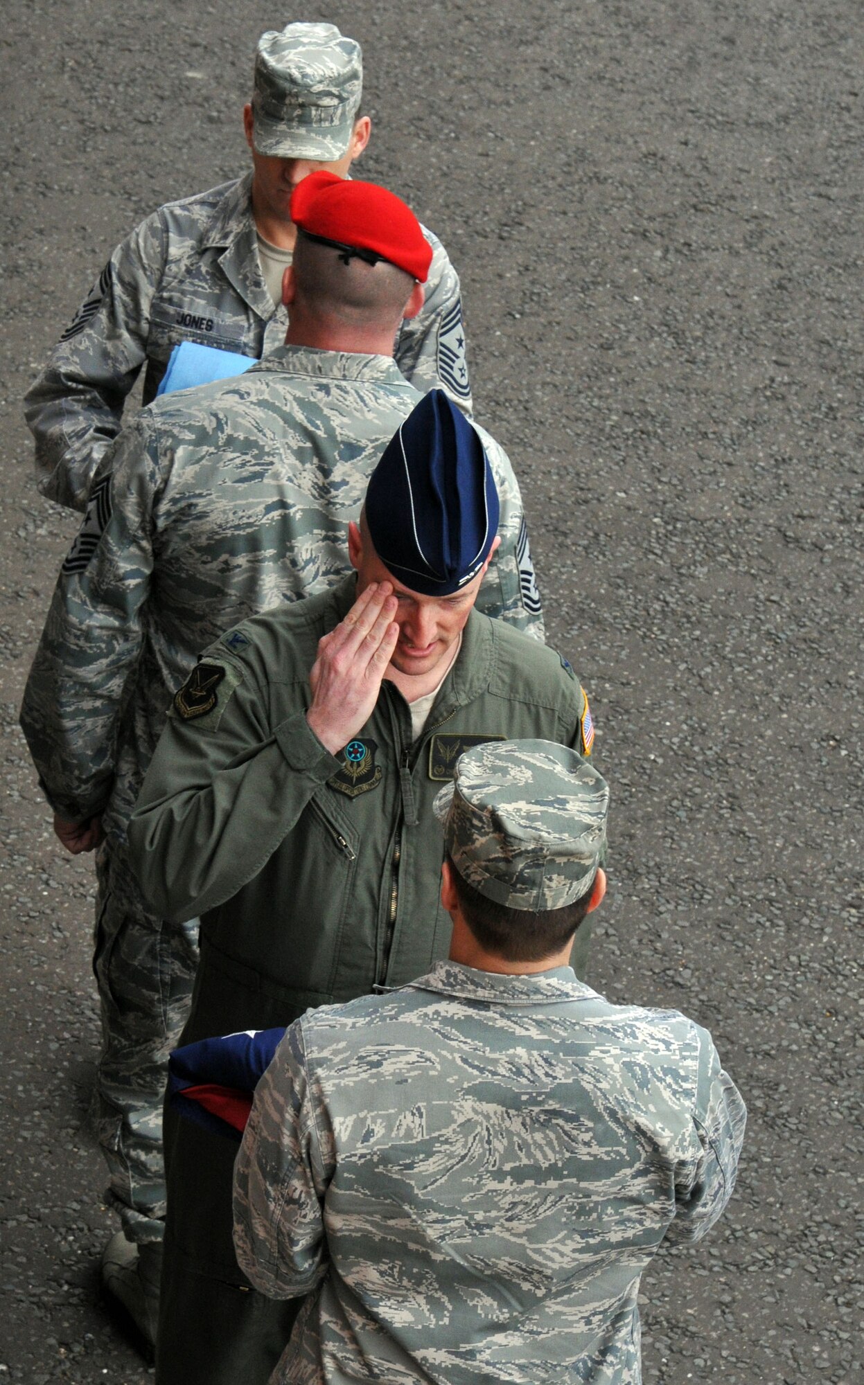 Col. Christopher Ireland, 352nd Special Operations Group commander, salutes the folded American Flag during a retreat ceremony March 29, 2013, at RAF Mildenhall, England.  The retreat ceremony was one of many events that happened during the 352nd SOG Heritage Week March 25 to 29. (U.S. Air Force photo by Airman 1st Class Kelsey Waters/Released)