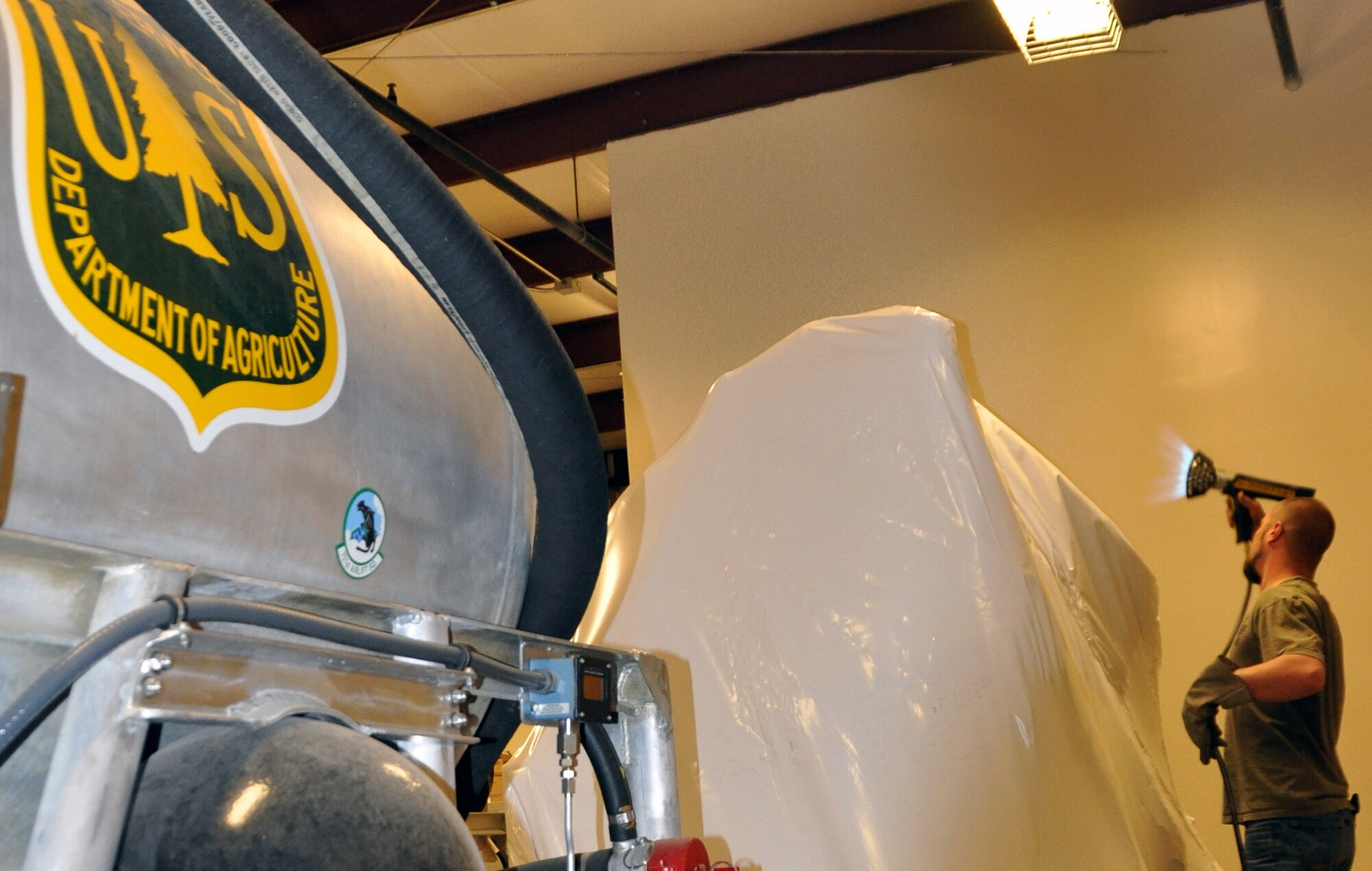 PETERSON AIR FORCE BASE, Colo. A boat storage technician contracted by the
U.S. Forest Service shrink wraps a U.S. Forest Service-owned Legacy Modular
Airborne Fire Fighting System Mar. 26 to prepare it for transport from
storage at the 302nd Airlift Wing here. The Legacy System was first used by
the 302nd Airlift Wing when the Colorado Reserve wing took on the MAFFS
mission in 1993. In 2009 the 302nd AW received two U.S. Forest Service MAFFS
II Systems, replacing the Legacy System. The MAFFS Legacy Systems were the first of their kind, built in the 1970s and were the first modular airborne fire
fighting equipment used by the DOD. The MAFFS Legacy System will be returned
to the U.S. Forest Service for its final disposition. (U.S. Air Force
photo/Master Sgt. Daniel Butterfield)