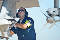 Tech Sgt. Tony Perez, Texas Air National Guard F-16 crew chief, arms the ordinance by removing the safety pins March 13, at Joint Base San Antonio-Lackland. (U.S. Air Force photo by Benjamin Faske) (released)