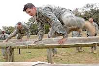 Soldiers attending the officer leadership course, traverse over an obstacle during the confidence course March 7, at Joint Base San Antonio-Camp Bullis (U.S. Air Force photo by Benjamin Faske) (released)