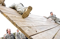Soldiers attending the officer leadership course, scale the angled wall on the obstacle course March 7, at Joint Base San Antonio-Camp Bullis (U.S. Air Force photo by Benjamin Faske) (released)