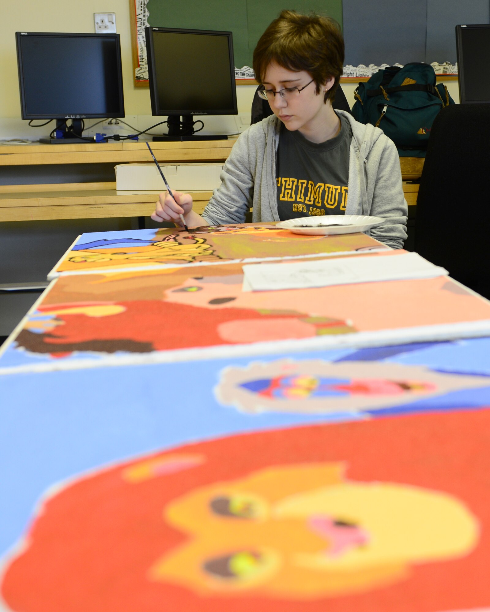 ROYAL AIR FORCE LAKENHEATH, England — Carly O’Rourke, daughter of Nancy O’Rourke, Department of Defense teacher, adds the final touches to the Lion King mural, April 1, 2013. Eight students from Lakenheath High School volunteered to paint tiles for 12 pediatrics rooms; each room has a different theme. The tiles are scheduled to be completed by May. (U.S. Air Force photo by Staff Sgt. Stephanie Mancha)