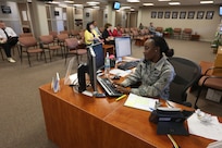 Airman 1st Class Tessie Odhiambo, 902nd customer support I.D. card section, answers the phone while scheduling appointments March 1 at Joint Base San Antonio-Randolph’s Pitsenbarger Hall. (U.S. Air Force photo by Joshua Rodriguez)