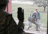 U.S. Air Force Airman from the 343d Training Squadron are conducting expeditionary ground combat training at the Joint Base San Antonio-Camp Bullis Combined Arms Collective Training Facility (CACTF) March 15, 2013. The Camp Bullis CACTF in San Antonio is a 25+ acre site with 16 structures agumented with a sports field, underground traininer , landing/pick-up zones, and city clutter. This allows for realistic training along with accurate and timely feedback for force-on-force and other operations. (U.S. Air Force photo by Joshua Rodriguez/released)