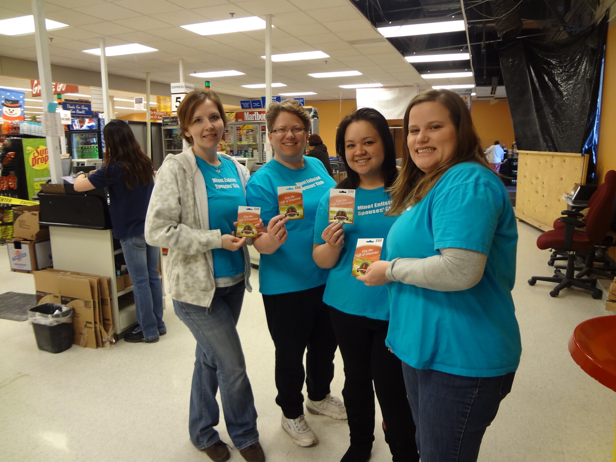 MINOT AIR FORCE BASE, N.D. -- The Minot Enlisted Spouses' Club conducted a commissary gift card giveaway March 30, as one of its many community outreach endeavors. The MESC contribution of $300 towards the grocery expenses of commissary shoppers during the Easter weekend was well received. A number of commissary patrons were further inspired to "pay it forward" by purchasing gift cards for other patrons. For more information about the MESC, please visit www.minotesc.org or  www.facebook.com/minotspouses. (Courtesy photo)
