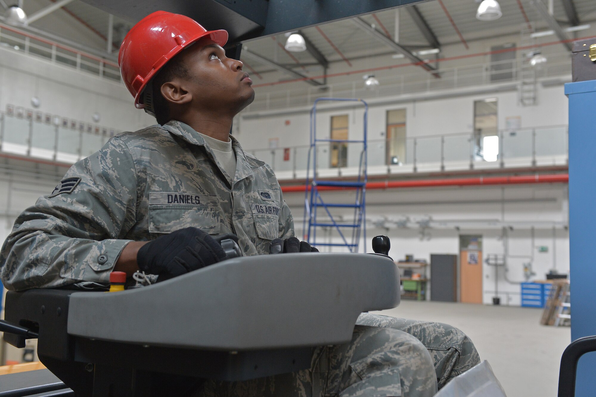 Senior Airman Howard Daniels, 1st Combat Communications Squadron radio frequency transmissions journeyman, moves faulty equipment on Ramstein Air Base, Germany, March 25, 2013. Daniels was recently awarded the Thunderbolt award for his superior achievements and work performance. (U.S. Air Force photo/Airman 1st Class Holly Cook)