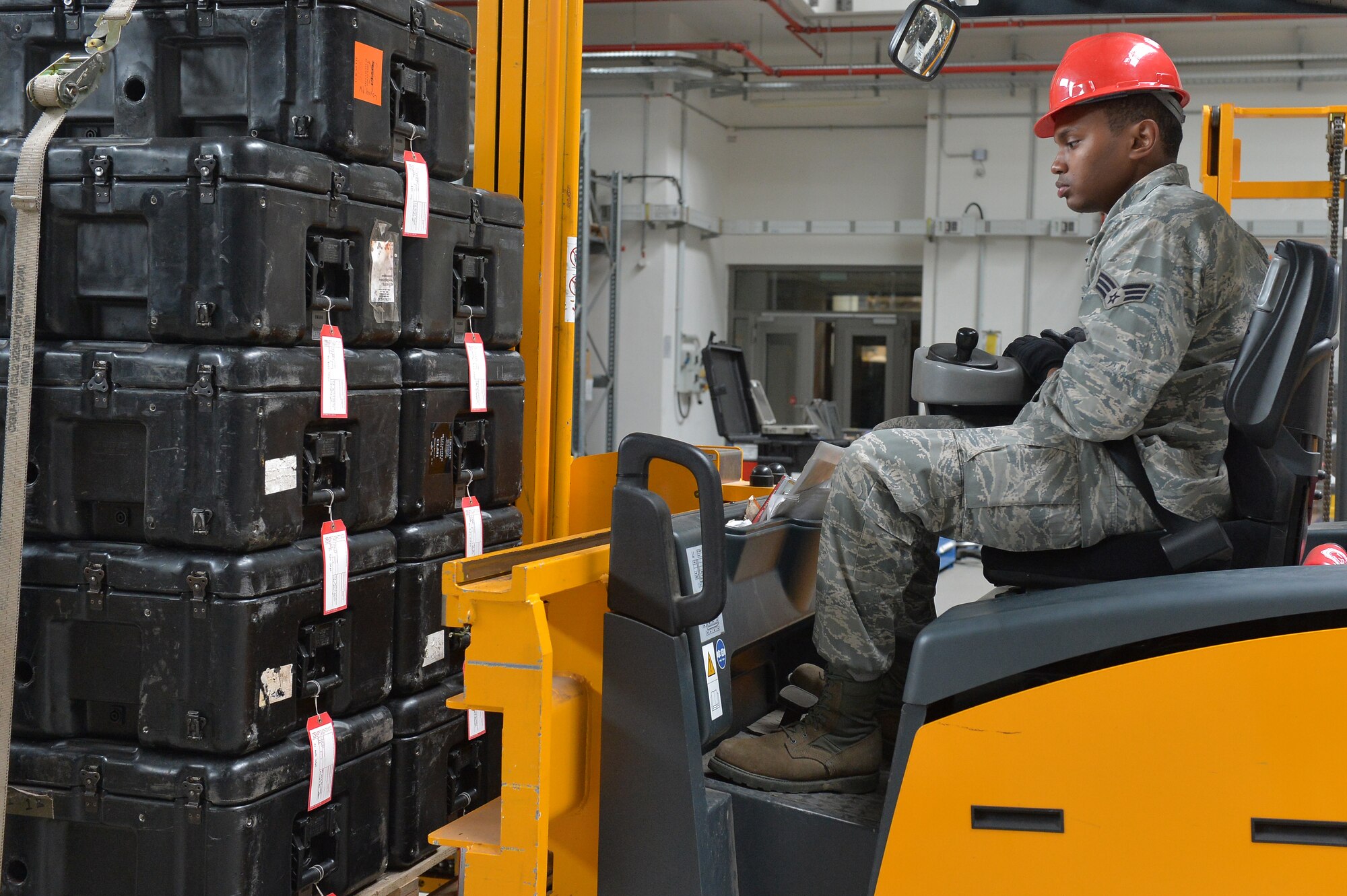 Senior Airman Howard Daniels, 1st Combat Communications Squadron radio frequency transmissions journeyman, moves faulty equipment on Ramstein Air Base, Germany, March 25, 2013. Daniels was recently awarded the Thunderbolt award for his superior achievements and work performance. (U.S. Air Force photo/Airman 1st Class Holly Cook)
