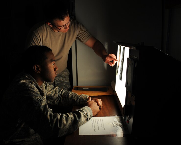 Senior Airman Josh Martinez and Airman 1st Class Javaris Wise, 2nd Maintenance Squadron non-destructive inspection, look for cracks on flap tracks from a B-52H Stratofortress using an x-ray machine on Barksdale Air Force Base, La., April 3, 2013. NDI Airmen look for cracks on parts using specialized equipment on the surface and subsurface level. (U.S. Air Force photo/Senior Airman Sean Martin)