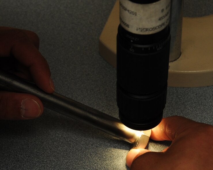 Senior Airman Josh Martinez, 2nd Maintenance Squadron non-destructive inspection, places a B-52H Stratofortress part under a video microscope on Barksdale Air Force Base, La., April 3, 2013. The microscope magnifies pieces of the part making it easier to inspect. (U.S. Air Force photo/Senior Airman Sean Martin)
