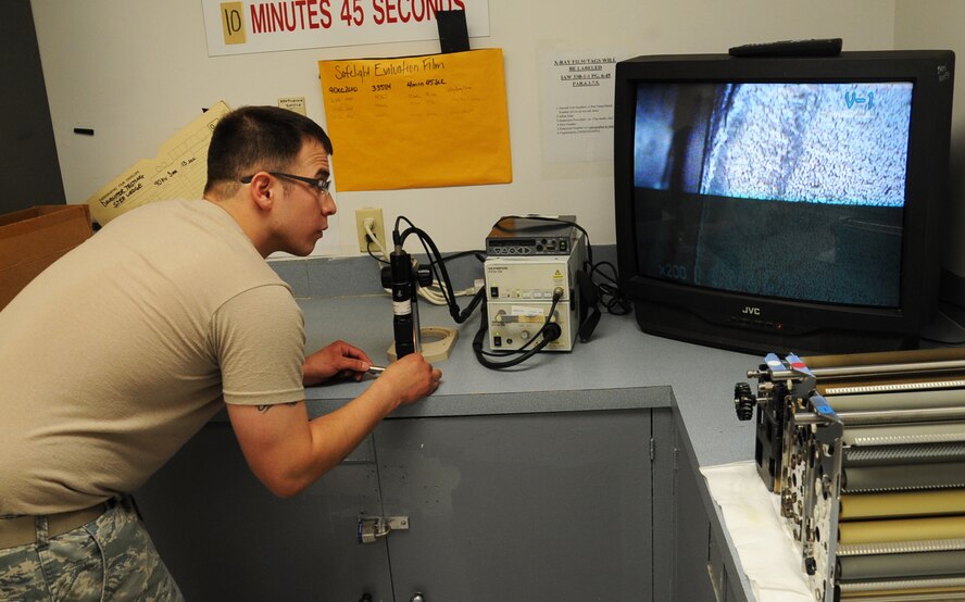 Senior Airman Josh Martinez, 2nd Maintenance Squadron non-destructive inspection, looks for cracks on a B-52H Stratofortress part using a video microscope on Barksdale Air Force Base, La., April 3, 2013. The microscope magnifies pieces of the part making it easier to inspect. (U.S. Air Force photo/Senior Airman Sean Martin)