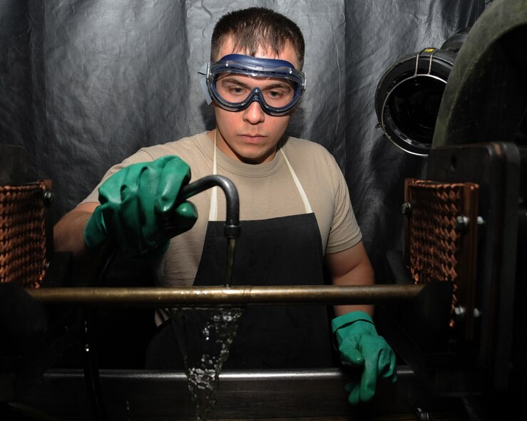Senior Airman Josh Martinez, 2nd Maintenance Squadron non-destructive inspection, sprays a part of a B-52H Stratofortress with a magnetic metal in a magnetic particle inspection booth on Barksdale Air Force Base, La., April 3, 2013. The liquid is used to detect small cracks on the part that would be missed by the human eye. (U.S. Air Force photo/Senior Airman Sean Martin)