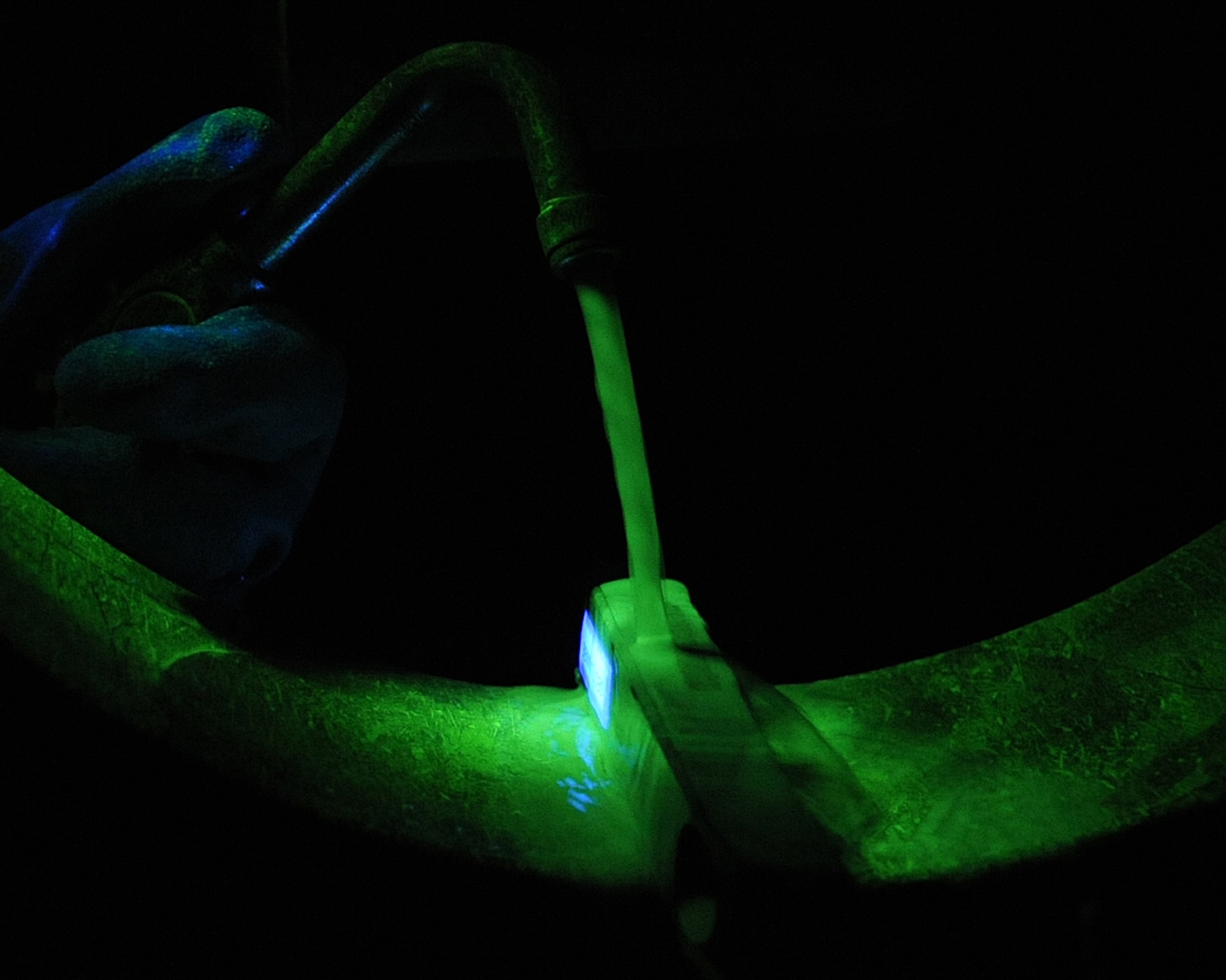 A part from a B-52H Stratofortress is magnetized in a magnetic particle inspection booth on Barksdale Air Force Base, La., April 3, 2013. The piece is magnetized using magnetic metals which gather and form a clot on the cracked area. (U.S. Air Force photo/Senior Airman Sean Martin)