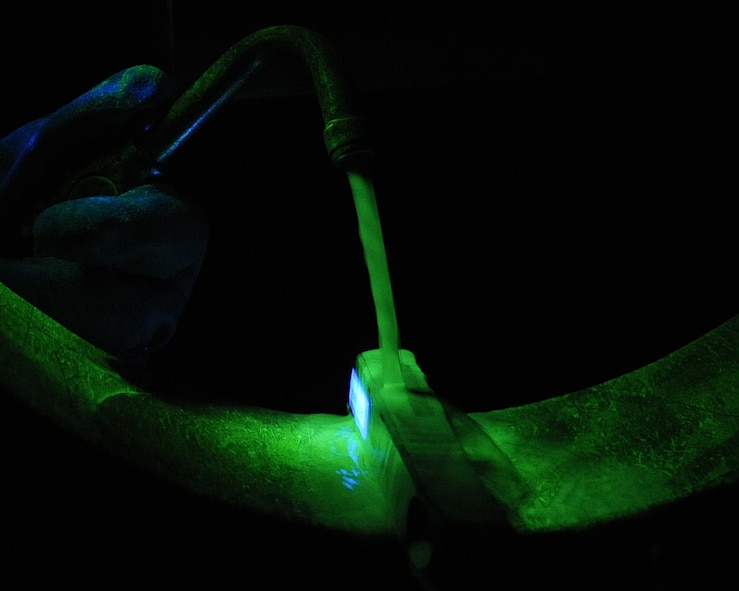 A part from a B-52H Stratofortress is magnetized in a magnetic particle inspection booth on Barksdale Air Force Base, La., April 3, 2013. The piece is magnetized using magnetic metals which gather and form a clot on the cracked area. (U.S. Air Force photo/Senior Airman Sean Martin)