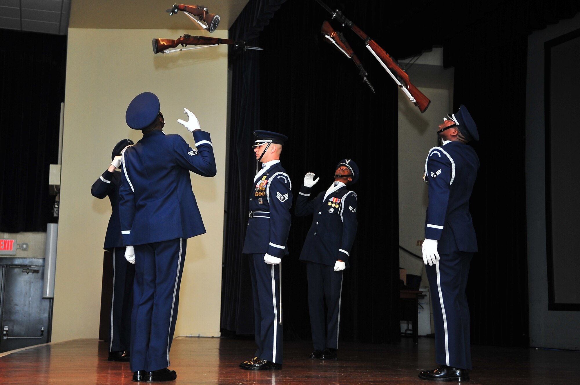 U.S. Air Force Honor Guard Drill Team members perform for Team Seymour during a recruitment brief on Seymour Johnson Air Force Base, N.C., Mar. 28, 2013. The drill commander stood stationary as four team members simultaneously hurled their 11-pound weapons over and around him. (U.S. Air Force photo by Airman 1st Class Aubrey White/Released)
