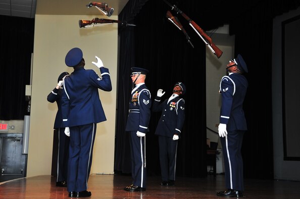 U.S. Air Force Honor Guard Drill Team members perform for Team Seymour during a recruitment brief on Seymour Johnson Air Force Base, N.C., Mar. 28, 2013. The drill commander stood stationary as four team members simultaneously hurled their 11-pound weapons over and around him. (U.S. Air Force photo by Airman 1st Class Aubrey White/Released)