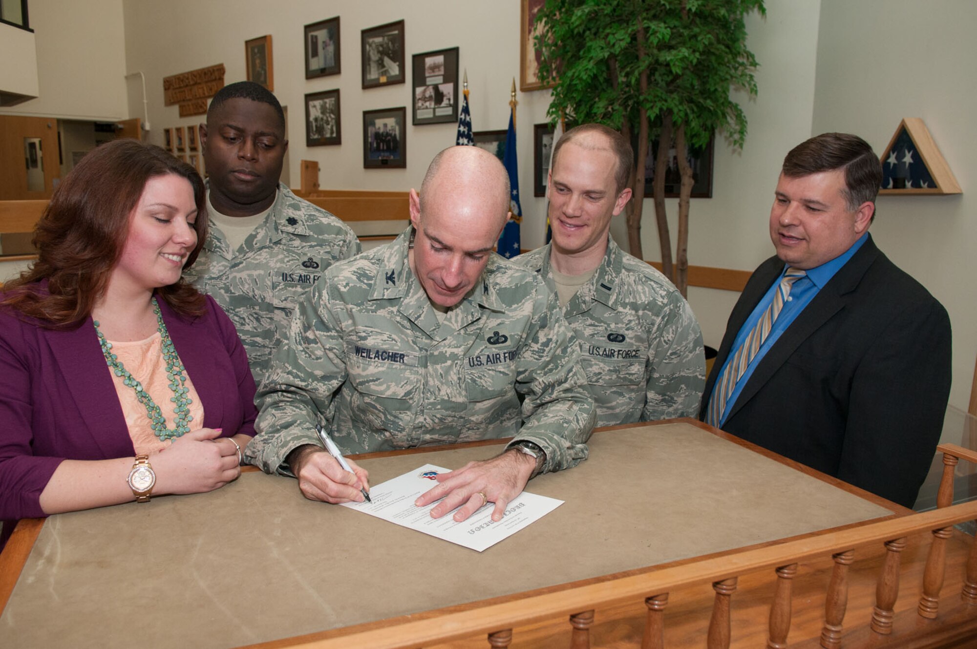 HANSCOM AIR FORCE BASE, Mass. – Col. Lester A. Weilacher, 66th Air Base Group commander, signs a proclamation declaring April 8 through 12 as the Holocaust Days of Remembrance on base. As part of the observance a Holocaust survivor will speak April 11 at noon at the Hanscom Conference Center. (U.S. Air Force photo by Rick Berry)