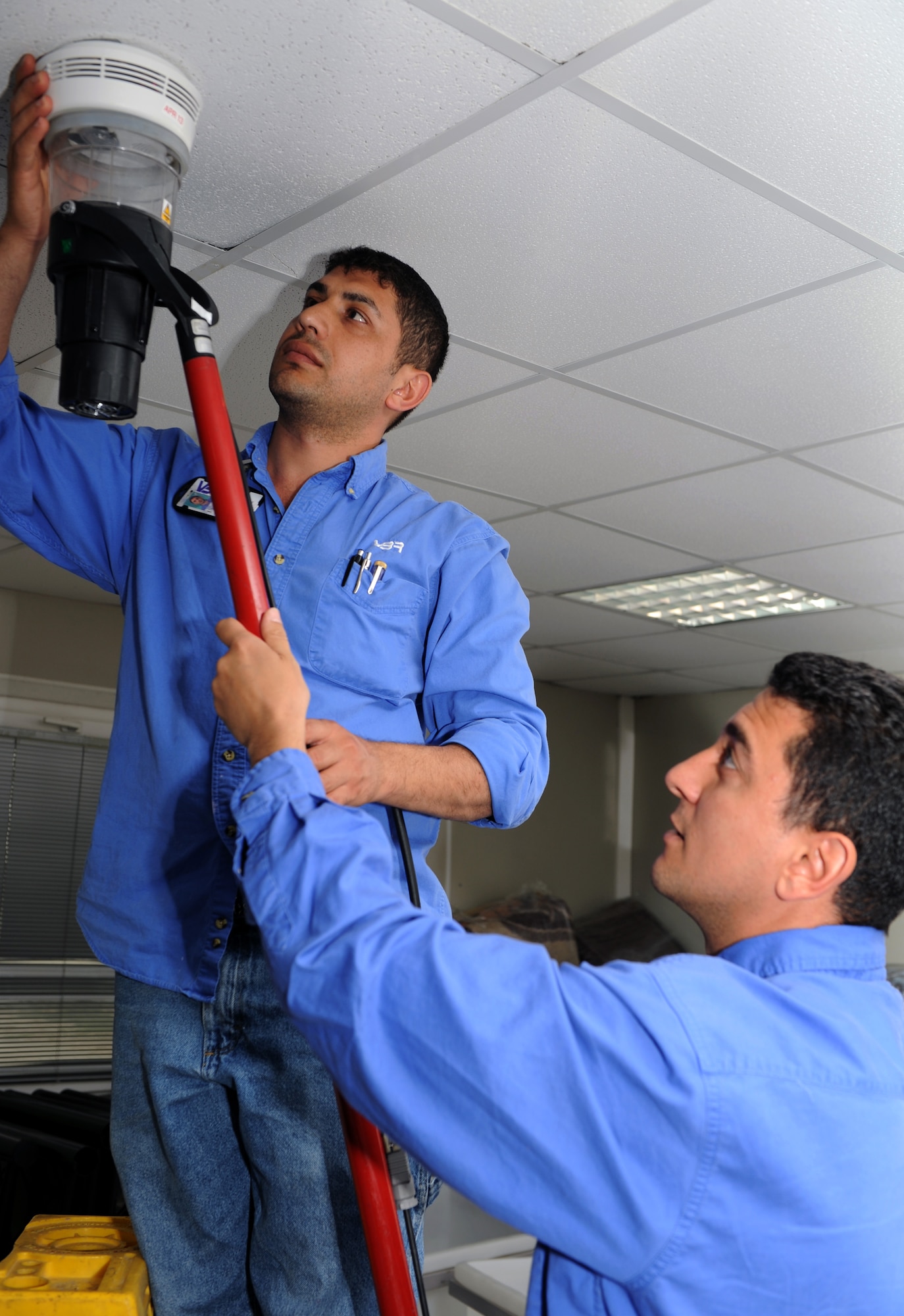 Ugur Uyar  (left) and Mehmet Sami Sevinc, both Vinnell-Brown and Root fire alarm technicians assigned to the 39th Civil Engineer Squadron, activate a fire alarm April 4, 2013, at Incirlik Air Base, Turkey. The VBR contractors are crucial to the Patriot Mission, ensuring incoming NATO service members have sufficient, safe living accommodations at Incirlik’s contingency lodging area. (U.S. Air Force photo by Staff Sgt. Marissa Tucker/Released)