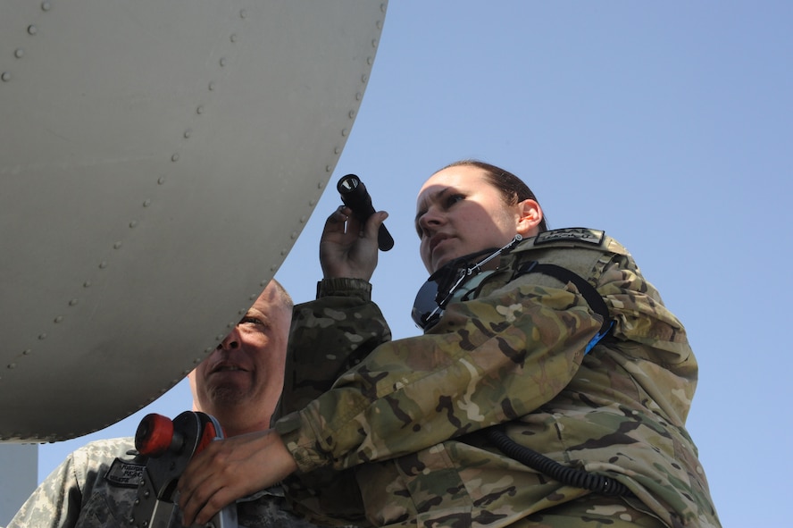 Staff Sgt. Amanda Griggs and Master Sgt. Joshua Vines, 455th Expeditionary Aircraft Maintenance Squadron engine specialists, perform an exhaust inspection on an A-10 Thunderbolt II fighter aircraft on Bagram Airfield, Afghanistan, April 4, 2013. The aircraft is deployed from Moody Air Force Base, Ga., as part of a new rotation. (U.S. Air Force photo/Staff Sgt. David Dobrydney)