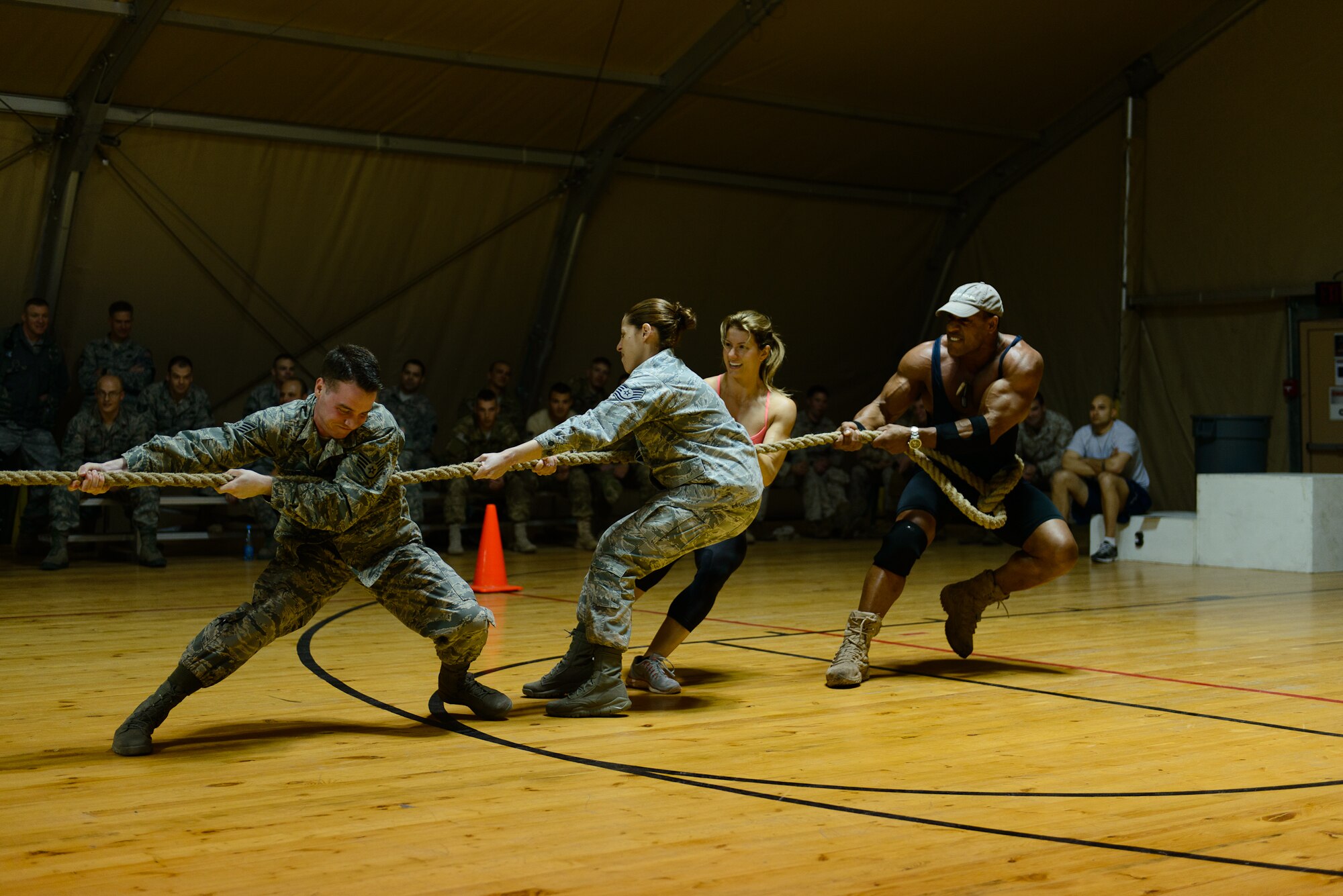 Left, Staff Sgt. James Grueser, Tech. Sgt. Tanya Sanchez, Phoenix and Militia compete in a tug-of-war game April 2, 2013, at Transit Center at Manas, Kyrgyzstan. Phoenix and Militia are two of four American Gladiators participating in an Armed Forces Entertainment tour with Billy Blanks. The gladiators put on a five-event competition with service members before signing autographs and taking photos with the troops. (U.S. Army photo/Sgt. Nathan Grill) 