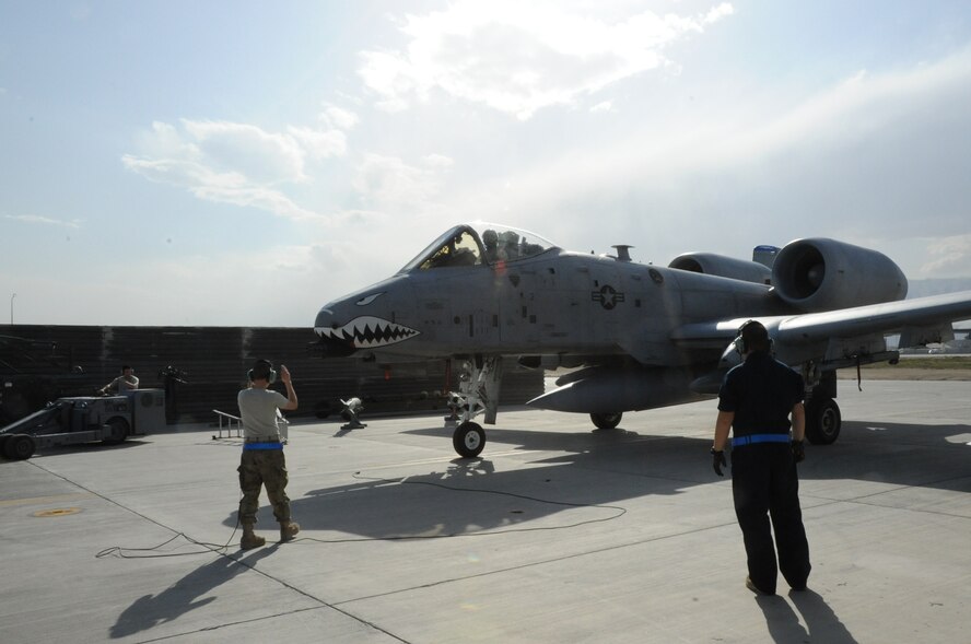 Staff Sgt. Rebecca Gaddy, 455th Expeditionary Aircraft Maintenance Squadron crew chief, guides an A-10 Thunderbolt II fighter aircraft into its parking place on Bagram Airfield, Afghanistan, March 31, 2013. Deployed from Moody Air Force Base, Ga., this aircraft was the first to arrive for the latest deployment rotation. (U.S. Air Force photo/Staff Sgt. David Dobrydney)