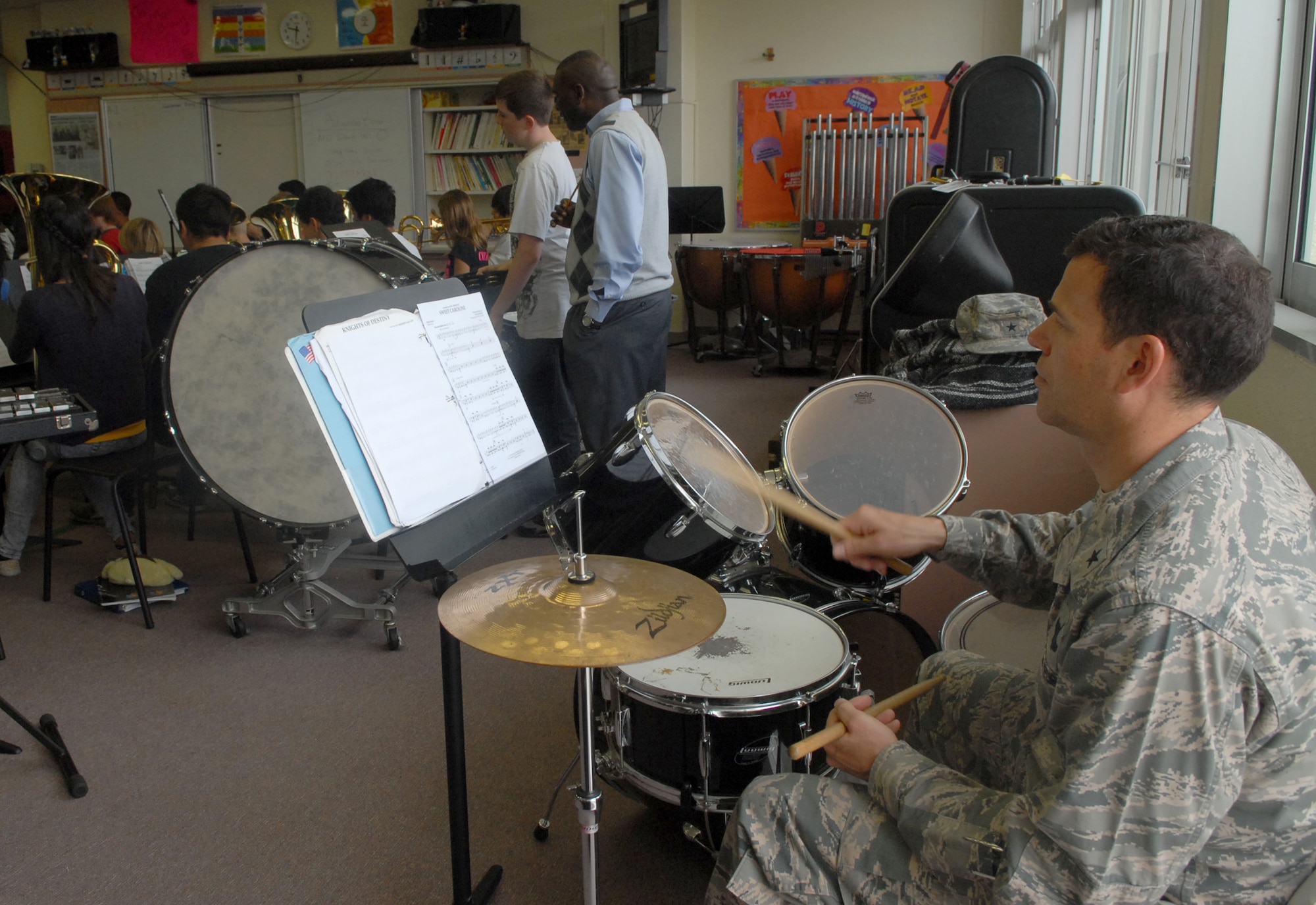 U.S. Air Force Brig. Gen. Matt Molloy, 18th Wing commander, practices with the Kadena Middle School advanced band on Kadena Air Base, Japan, April 3, 2013. The band played "Hey, Soul Sister" by Train and "Sweet Caroline" by Neil Diamond during the practice. (U.S. Air Force photo by Staff Sgt. Lauren Snyder/Released)
