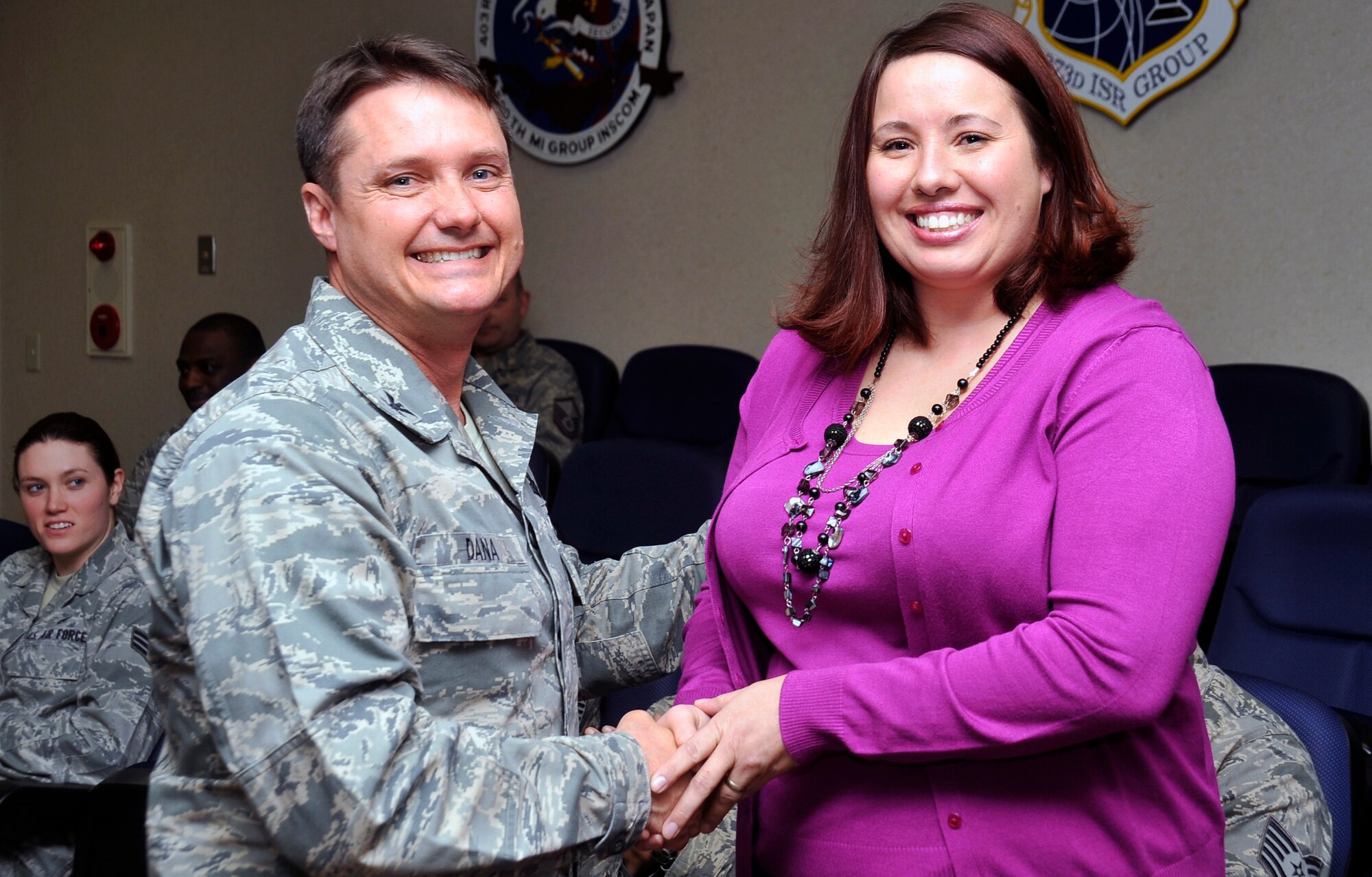 Muriel Cedillo, spouse of U.S. Air Force Tech. Sgt. Jacob Cedillo, 35th Aircraft Maintenance Squadron, is congratulated by Col. Matthew Dana, 35th Fighter Wing vice commander, during a recognition ceremony at Misawa Air Base, Japan, March 28, 2013. Cedillo was named Pacific Air Forces Spouse of the Year. (U.S. Air Force photo by Airman 1st Class Zachary Kee)