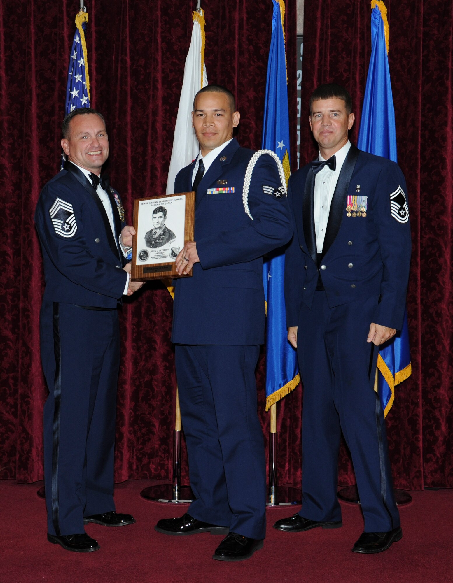 U.S. Air Force Senior Airman Larson Chun, 18th Operations Support Squadron, receives the Levitow Award during his Airman Leadership School graduation on Kadena Air Base, Japan, March 29, 2013. This award, which is named after the Medal of Honor recipient John L. Levitow, recognizes Chun as the top of his class in a combined role as leader and scholar. (U.S. Air Force photo by Airman 1st Class Keith James/Released)