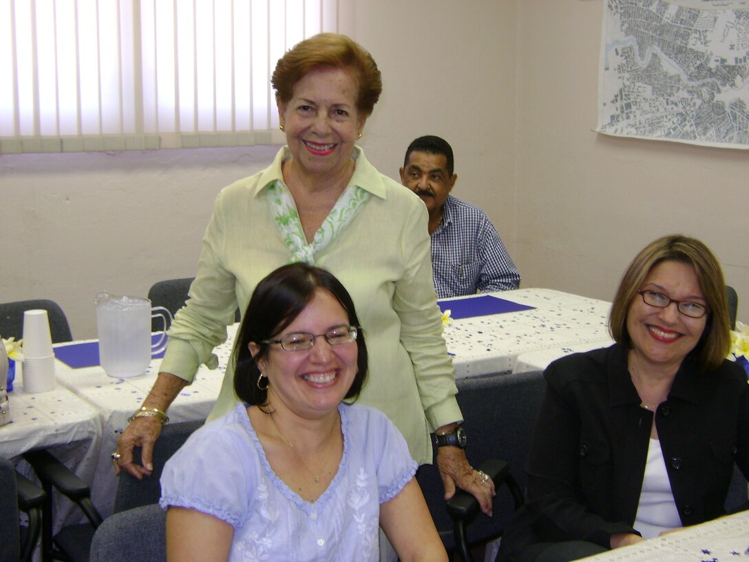 Beloved retiree Ernestina “Ernie” Miranda (center) served as a “godmother,” counselor, mentor and role model for many Corps employees over the years. Pictured today, along with Angela Muños-Caro (left) and Gisella Román (right), Miranda is still young at heart at 89. 