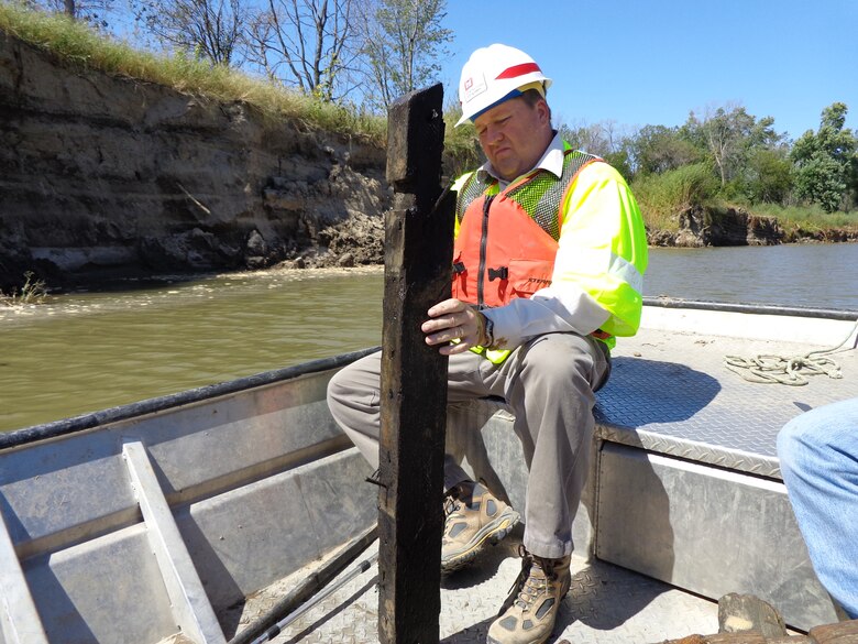 Luke Wallace inspects ship timbers after the contractor reported an inadvertent discovery on a recent project.