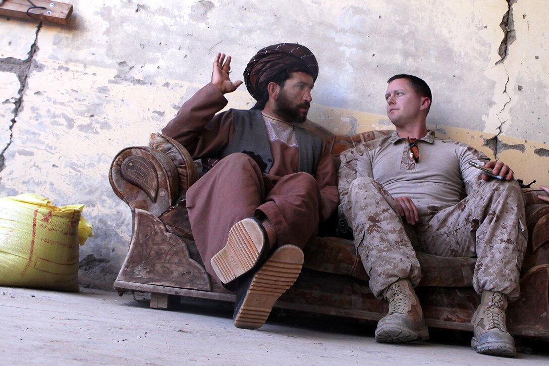 U.S. Marine Corps Maj. Burke Eltringham, right, talks with Afghan Uniform Police Sgt. Lala Jan, the training chief, at the Kajaki police headquarters in Helmand province, Afghanistan, March 31, 2013. Eltringham is the commanding officer of the U.S. Marine-led Kajaki Police Advisor Team.