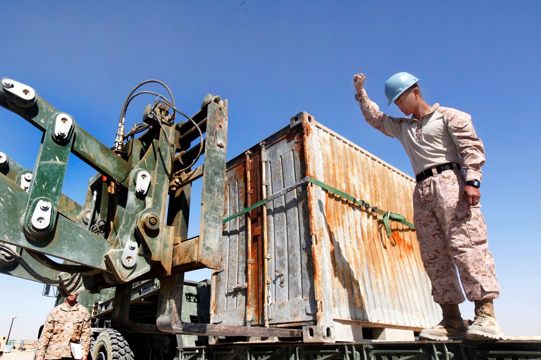 U.S. Marine Lance Cpl. Nelson Santos guides a 624KR Tractor Rubber-tired Articulated Steering Multipurpose, or TRAM, vehicle on Camp Leatherneck in Afghanistan's Helmand province, April 2, 2013. Santos, a motor vehicle operator, is assigned to Marine Wing Support Squadron 271. 