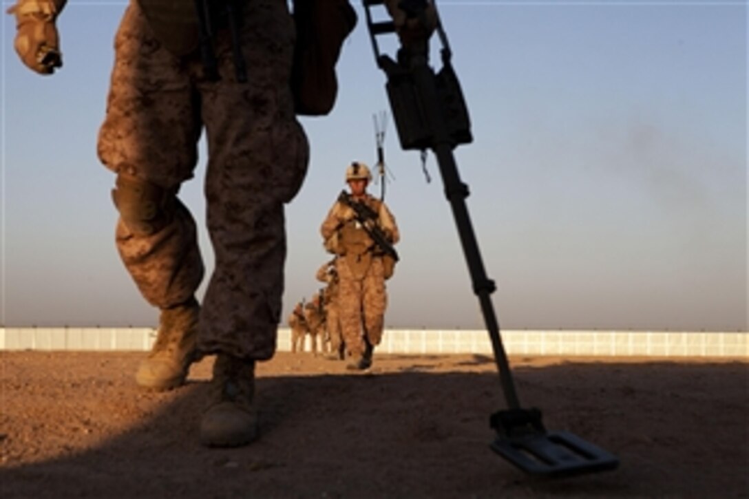 U.S. Marine Corps Lance Cpl. Ryan Burdge, foreground, uses a metal detector during Counter Improvised Explosive Device training at Camp Leatherneck, in the Helmand province of Afghanistan on April 2, 2013.  Marine Corps instructors with the 2nd Combat Engineer Battalion led the training, which covered tactics and techniques in an urban operations framework