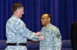 Brig. Gen. William J. Johnson, is pinned by Maj. Gen. William D. Wofford, the adjutant general of Arkansas, becoming the first African American general in the 203 year history of the Arkansas National Guard.