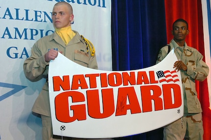 Cadets from the National Guard Youth ChalleNGe program hold a Dale Earnhardt Jr. autographed trunk lid from the No. 88 National Guard Sprint Cup Car during the 2008 ChalleNGe Champions Gala Feb. 26 at the JW Marriott ballroom in Washington. Earnhardt donated the item and an auto racing jacket, which raised more than $25,000 for the Guard's Youth ChalleNGe program. Hendrick Motorsports auto racing team owner Rick Hendrick matched the auctioned lid with a $20,000 donation. Youth ChalleNGe has helped more than 77,000 troubled teenagers earn their GEDs, learn life skills, return to school, enroll in college or join the military. More than 1,000 program supporters attended the event.