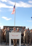 Lt. Col. James Starnes, commander of the 474th Civil Engineering Squadron, speaks at a ceremony Feb. 2 celebrating his unit's hard work building the Expeditionary Legal Complex. The complex includes a state-of-the-art courtroom designed to facilitate military commissions. Joint Task Force Guantanamo conducts safe and humane care and custody of detained enemy combatants. The JTF conducts interrogation operations to collect strategic intelligence in support of the Global War on Terrorism and supports law enforcement and war crimes investigations.