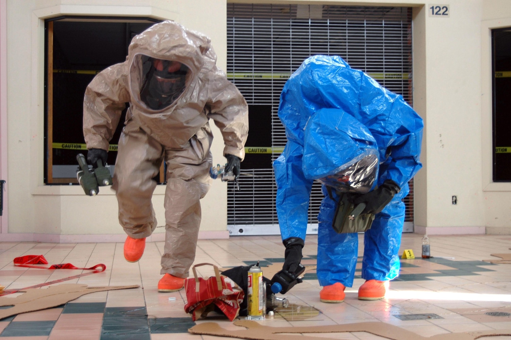 Two members of the 92nd Civil Support Team take a sample of a simulated hazardous substance in a Sparks, Nev., shopping mall during training on Nov. 25, 2005. The Nevada National Guard's civil support team was called to assist Las Vegas Metro Police on Feb. 28, 2008, with a suspicious substance that was later identified as deadly ricin. The team is one of 52 certified units nationwide to support local and state authorities at domestic incident sites by identifying hazardous agents and substances.