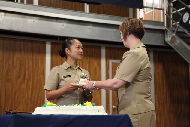 Master Chief Charlotte Osborn, command master chief, 1st Dental Battalion, 1st Marine Logistics Group, passes a piece of cake to Chief Petty Officer Sandra Go-Lubiano, a senior enlisted leader with 1st Dn. Bn., during the cake-cutting ceremony for the 120th anniversary of the chief petty officer rating, aboard Camp Pendleton, Calif., Monday, April 1, 2013. (U.S. Marine Corps photo by Cpl. Laura Gauna/Released)