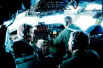 A Kansas Air Guard KC-135 aircrew discuss their mission while enroute to Palau.