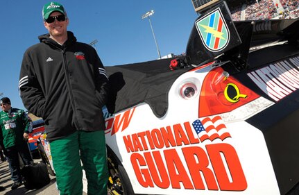 Dale Earnhardt Jr. stands with the No. 88 National Guard car March 9 at Atlanta Motor Speedway. Earnhardt and his team are now sixth among NASCAR's Sprint Cup leaders after he drove the No. 88 car to a third place finish in the Kobalt Tools 500. He drove the No. 5 Guard Car Saturday to a ninth-place finish and third place in the Nationwide Series standings.